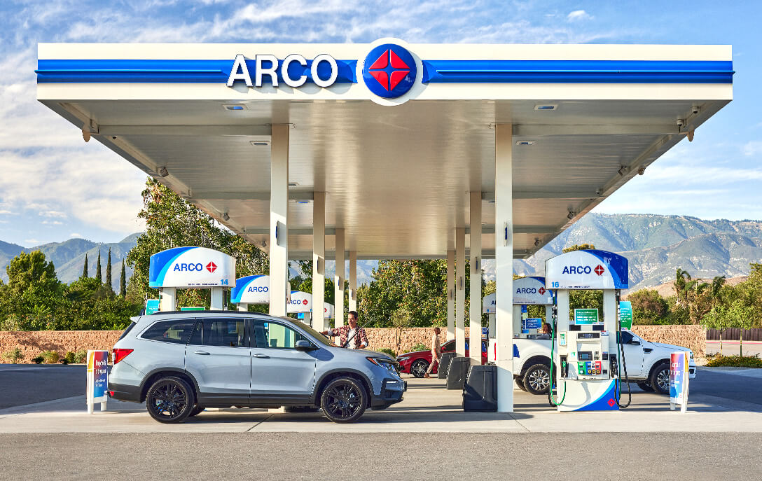 Modern gas station with fuel pumps under bright canopy — gas station and convenience store insurance